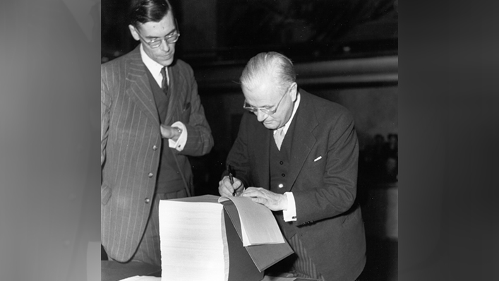 Mr. Dana Wilgress, a senior Canadian diplomat, signing the Final Act of the General Agreement on Tariff and Trade. The following year, he was elected the first Chairman of the GATT Contracting Parties.