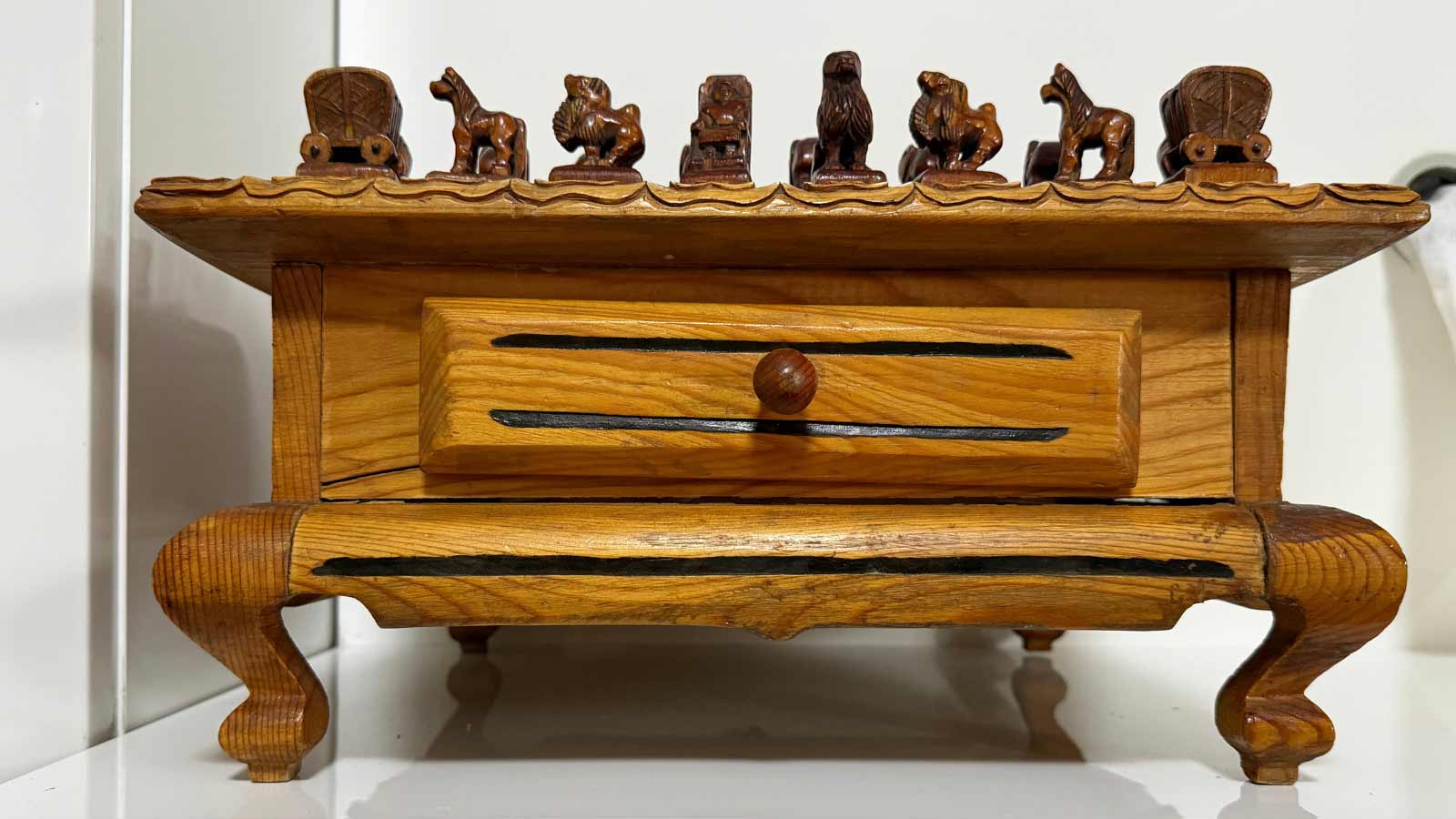 A handcrafted wooden chess board with intricately carved pieces by PUMA.